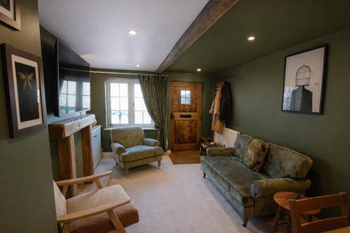 a living room with a couch and two chairs at Daisy Cottage - Framlingham in Framlingham