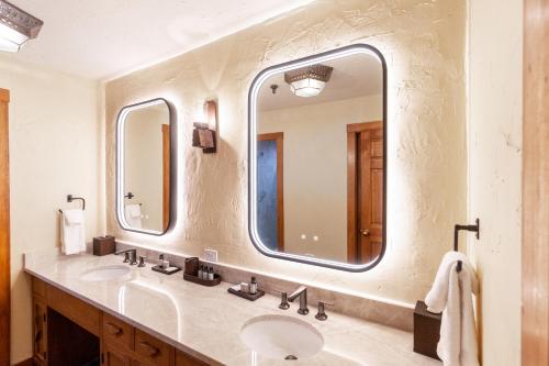 a bathroom with two sinks and a large mirror at Hotel Chimayo de Santa Fe in Santa Fe