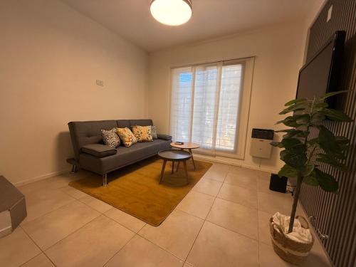 a living room with a couch and a table at Work & Stay Zarate in Zárate