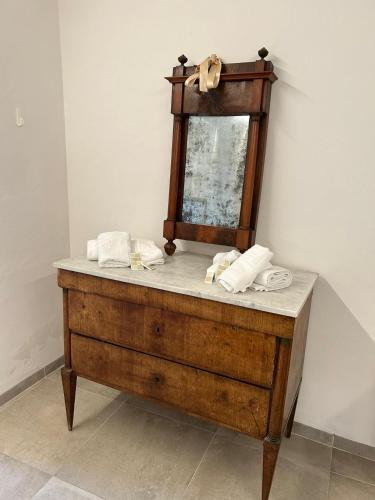 a wooden dresser with a mirror on top of it at Il pozzo & La volta in Siena