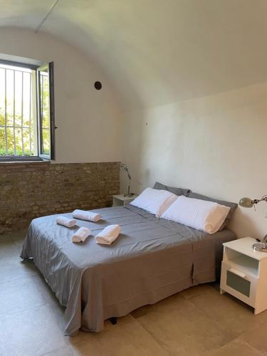a bedroom with a bed with two towels on it at Il pozzo & La volta in Siena
