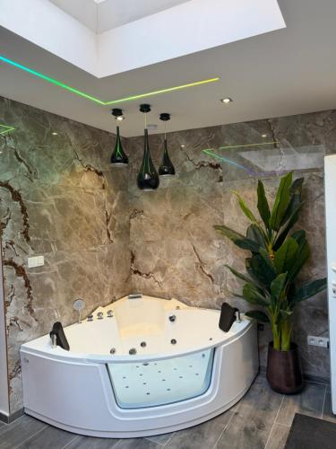 a bathtub in a room with a stone wall at Charnel - Suite Bali in Liège