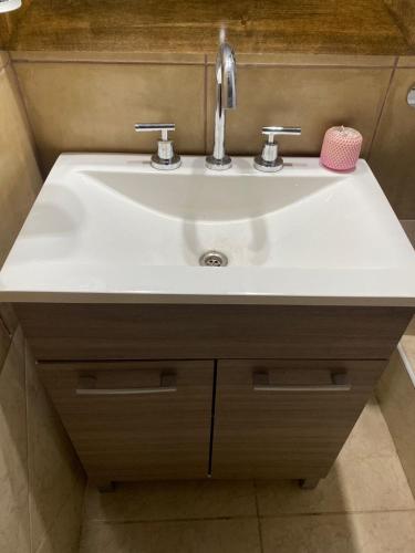 a bathroom sink with a white counter top at Departamentos la lucia in Villa Paula de Sarmiento
