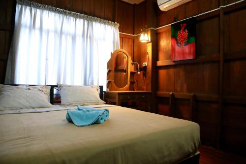 Ένα ή περισσότερα κρεβάτια σε δωμάτιο στο Siriwan Hostel