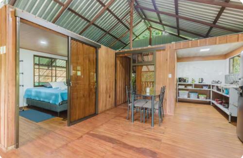 a bedroom with a bed and a table in a room at Sloth House Rio Celeste in Rio Celeste