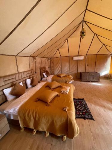 a bedroom with a large bed in a tent at Chez zakaria guest in Erfoud
