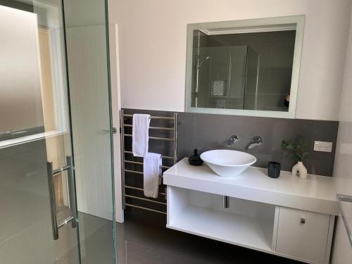 a bathroom with a white sink and a mirror at Sunny Clyde Getaway in the Heart of Clyde in Clyde
