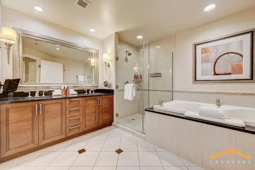 a bathroom with a tub and a sink and a shower at MGM Signature 03-818 Jacuzzi Studio in Las Vegas