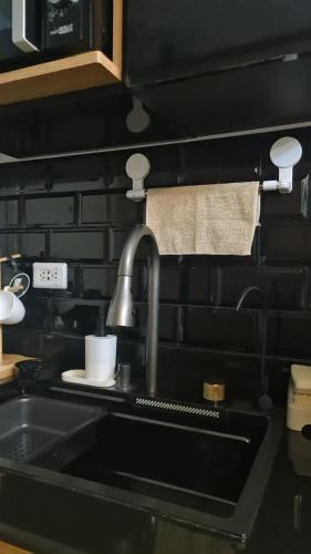 a kitchen counter with a sink and a sink at Cozy Sunset Condo Thompson Stay in Manila