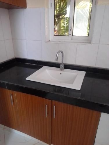 a white sink in a bathroom with a window at Wasini gardens,, vingazini in Mtwapa