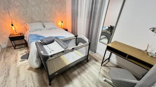 a bedroom with a bed and a desk and a mirror at Villamadrid Home in Madrid