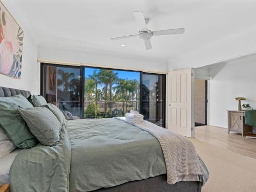 a bedroom with a bed and a large window at Elsinor 4 in Mulwala