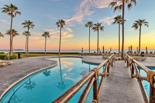 a pool at the beach with palm trees at Penthouse Beachfront at Sonoran Spa in Puerto Peñasco