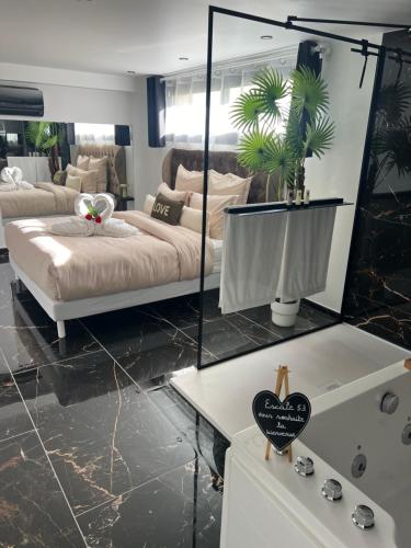 a master bedroom with a bed and a mirror at Escale 53 A 5 min aéroport Orly in Athis-Mons