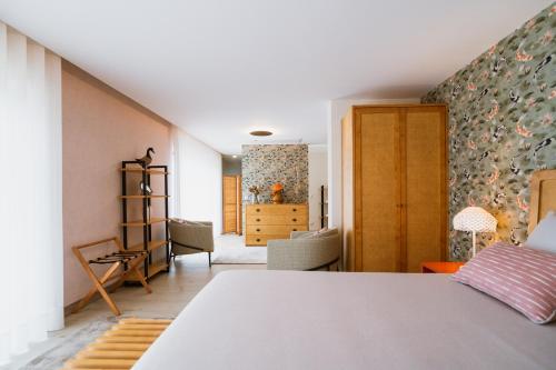 a bedroom with a bed and a living room at Quinta Clara in Vila Verde