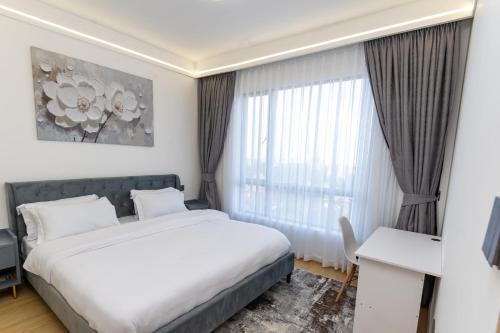 a hotel room with a bed and a desk at The Residence -Juction Mall in Nairobi