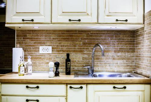 a kitchen counter top with a sink and a sink at Apartment Genius Loci in Split