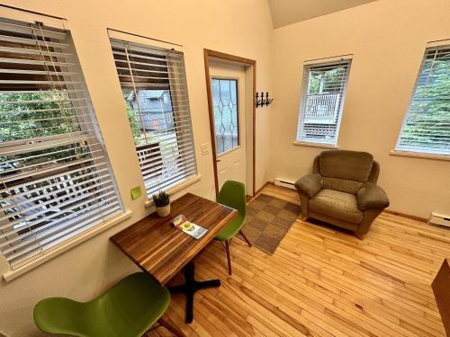 a living room with a table and a chair at Great Cabin In Close To Walking Trails And Beaches - 13T in Ucluelet