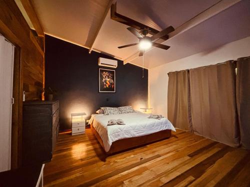 a bedroom with a bed and a ceiling fan at Hotel Mauka Boutique Villas in Cocles