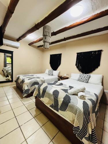 a bedroom with two beds in a room at Mayan Mittoz in Holbox Island