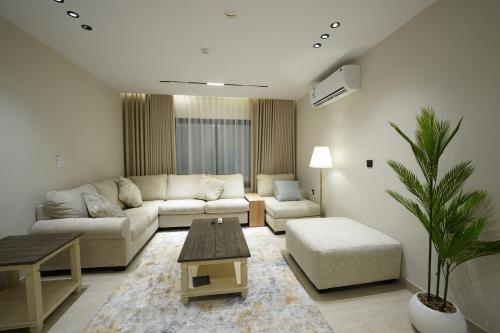 a living room with a couch and a table at Elite Alsultan in Al Khobar