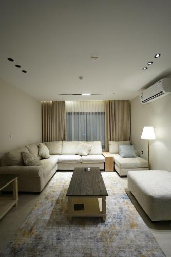 a living room with a couch and a coffee table at Elite Alsultan in Al Khobar