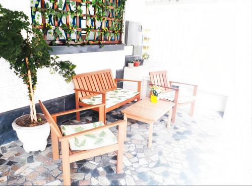 two chairs and a bench on a patio at Hotel e Pousada das Goianas in Santos