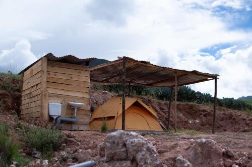 a building with a tent on a hill at Camping tres nevados in Urubamba