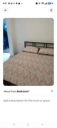 a bedroom with a bed with a bedspread on it at Xavier Heights Gate 1 Pad in Cagayan de Oro
