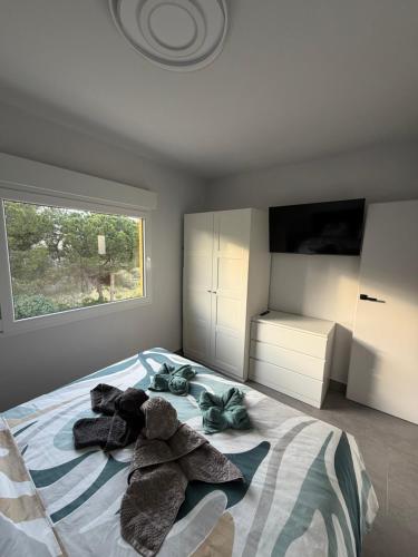 a bedroom with a bed with stuffed animals on it at Apartment A&T La Mata in La Mata
