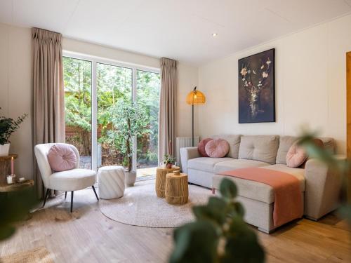 a living room with a couch and two chairs at Het Hertenpad in Hattemerbroek