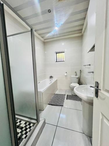 a bathroom with a toilet and a sink at Modern Comfort, Easy Access Everywhere in Vanderbijlpark
