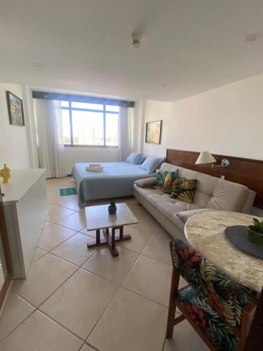 a living room with a couch and a table at Vitória Marina Flats in Salvador