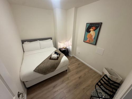 a bedroom with a bed and a picture on the wall at The Bourbon & Brass - Speakeasy-Inspired 2BDR in St. Charles