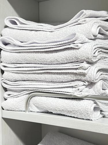 a stack of white towels sitting on a shelf at Stay Mokpo,2R1B,목포역,케이블카,동부시장,최대4인 in Mokpo