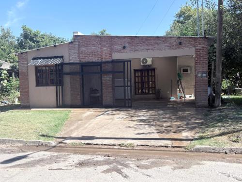 a small brick house with its door open at Casa saavedra in Estación Ramallo