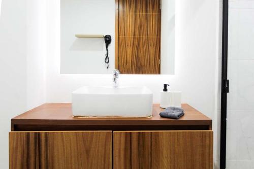 a bathroom with a sink and a mirror on a counter at Tribu Santa Tere in Guadalajara
