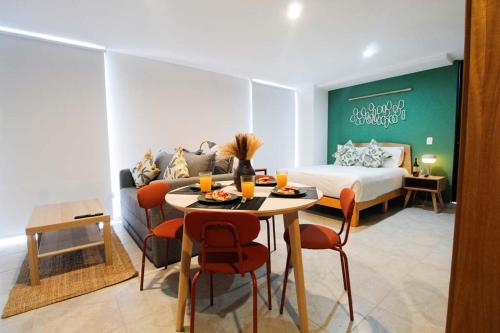 a room with a bed and a table and chairs at Tribu Santa Tere in Guadalajara