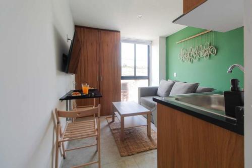 a kitchen with a sink and a living room at Tribu Santa Tere in Guadalajara