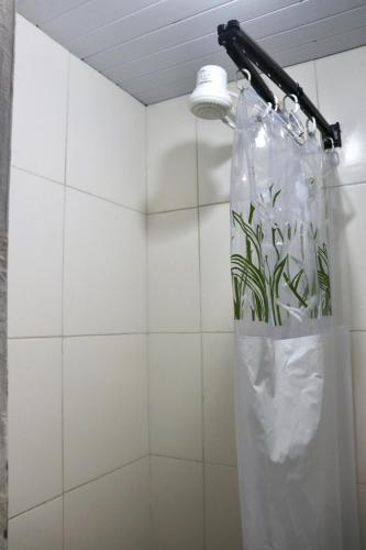 a shower with a plastic bag on a wall at Casaraosete7 in Salvador