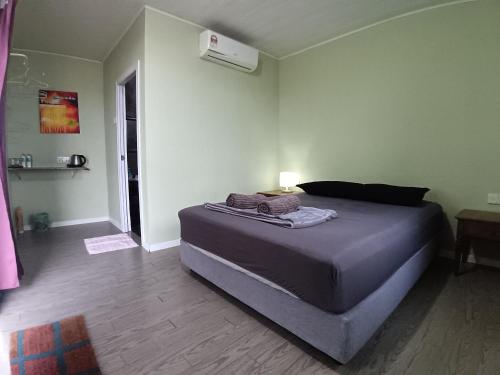a bedroom with a large bed in a room at Sunset Beach House in Kudat