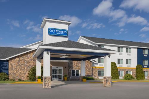 a hotel with a sign on the front of a building at City Express by Marriott Bemidji in Bemidji
