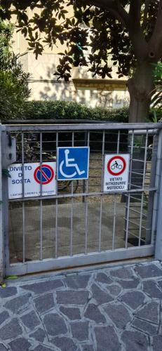 a gate with street signs on it at La Dépendance in Alassio