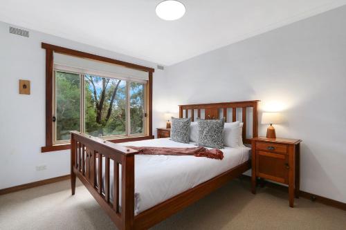 a bedroom with a large bed and a window at Blue Moon in Beechworth