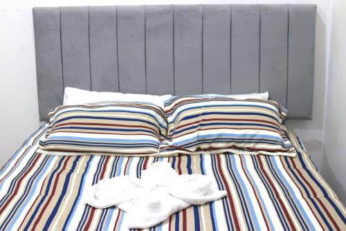 a bed with two pillows and two towels on it at Qinty Nature Ecolodge in Cusco