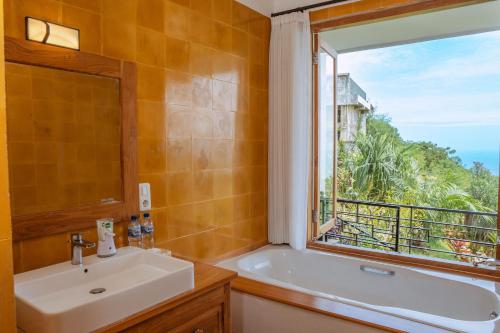 a bathroom with a sink and a window at LiRi Villa - Ocean, hills, valley view in Lovina