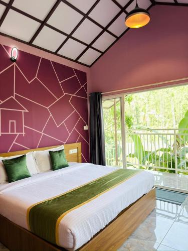 a bedroom with a large bed with a purple wall at Himadri Retreat Wayanad in Kaniyāmbetta