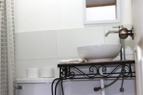 a bathroom with a sink and a bowl on a shelf at Qinty Nature Ecolodge in Cusco