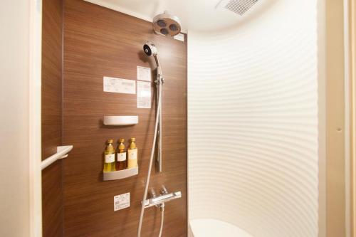 a shower stall in a bathroom with wine bottles at Shimobe Hotel in Minobu