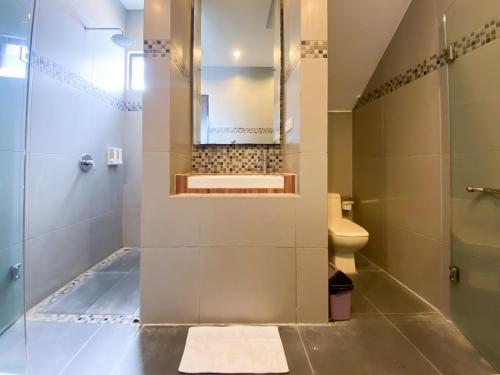 a bathroom with a shower and a sink and a toilet at The Lavana Dzawani Villa Berawa Kuta Bali 3 Bedroom Villa in Canggu